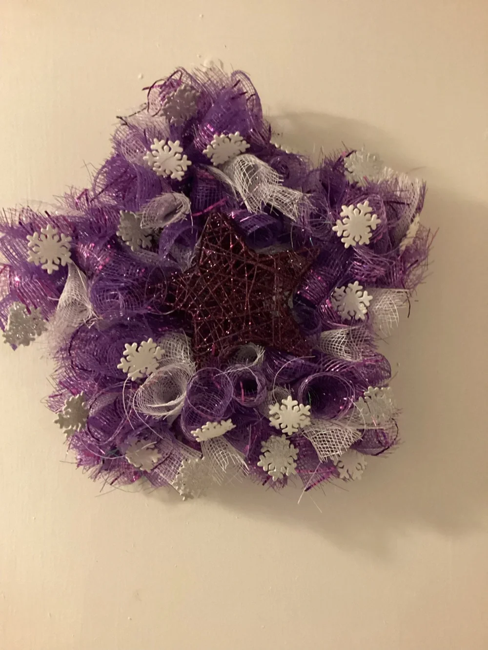 Purple star wreath with snowflakes, approximately 13 inches